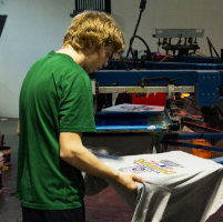 worker designing a custom silkscreen t-shirt